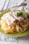 Pasta Alfredo with chicken and cream sauce close-up. Vertical