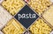 Pasta assortment and blackboard for text