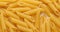 pasta backgroud - macro view of Dry Authentic Italian penne