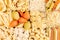 Pasta background assortment of different kinds italian macaroni in chess cells top view.