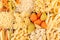 Pasta background assortment of different kinds italian macaroni in chess cells top view.