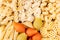 Pasta background assortment of different kinds italian macaroni in chess cells top view.