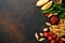 Pasta background. Pasta rigati, tomato ketchup sauce, olive oil, spices, parsley, and fresh tomatoes on a dark slate table. Food