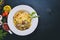 Pasta with bacon, cherry tomatoes, olives, and mushrooms with parmesan cheese. Italian food.