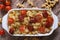 Pasta baked with cherry tomatoes and sausages top view