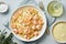 Pasta bavette with fried shrimps, bechamel sauce, thyme on blue table, top view, italian cuisine