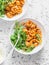 Pasta with beans, tomato sauce, parmesan and arugula on light background, top view