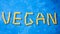 Pasta on blue background. inscription vegan pasta