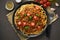 Pasta Bolognese bucatini with mincemeat and tomatoes, dark wooden background, top view