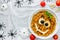Pasta bolognese on Halloween party, fun recipe for kids to dinner or lunch, edible cute monster face from fusilli in sauce