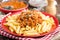 Pasta bolognese. Pasta served with a sauce of ground beef meat, tomato, onion, carrot and thyme