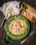 Pasta Carbonara in green plate , parmesan, spices and seasonings