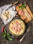 Pasta carbonara in vintagen pan with parmesan cheese ,spices and herbs on cutting board