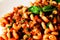 Pasta Cavatappi with homemade marinara sauce and basil leaves on top. Closeup