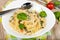 Pasta with chicken meat, spinach, tomatoes, cream sauce and cheese