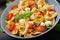 Pasta colored farfalle salad with tomatoes