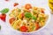 Pasta colored farfalle salad with tomatoes