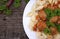 Pasta Conchiglie and meatballs with tomato sauce on rustic wooden background. Top view