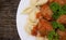 Pasta Conchiglie and meatballs with tomato sauce on rustic wooden background. Top view