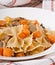 Pasta in cream sauce with slices of pumpkin and mushroom