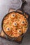 Pasta decorated with meatballs eyes closeup in the plate Menu on Halloween. Vertical top view