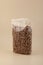 Pasta di Lino. Flaxseed gluten free pasta in transparent bag on beige background. Fusilli made from flax and corn flour. Low