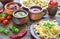 Pasta with different kinds of sauce on the wooden background