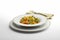 Pasta dish Macaroni and vegetables with napkin and fork