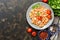 Pasta with feta cheese, sauce and baked tomatoes. Italian dish. Dark background, flat lay.