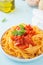 Pasta fettuccine with spicy tomato sauce, bell peppers and basil
