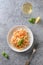 Pasta fettuccini with shrimps, prawn decorated basil and wineglass on grey. View from above. Vertical shot