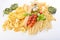 Pasta with fresh tomatoes, basil and olive oil on light shabby rustic background, top view, border. Pasta with