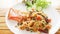 Pasta with giant prawn, olives, tomatoes, and chilli on wood background