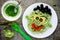 Pasta with green vegetables pesto shaped Frankenstein - healthy