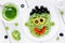 Pasta with green vegetables pesto shaped Frankenstein monster -