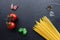 Pasta ingredients on black slate background