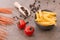 Pasta made from wheat semolina, azuki beans and quinoa with cherry tomates and parmesan cheese on a brown textured background