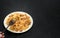 Pasta with meat on a dark background. on a fork, pasta in the shape of a butterfly with meat . the view from the top. space for