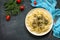 Pasta with meat liver and onion sauce on a stone table. Top view on a flat background lay. Copy space