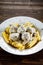 Pasta with meatballs and sauce on wooden table