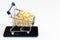 Pasta with mini cart supermarket on a smartphone, on white background. Concept of delivery, online shopping