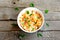 Pasta with mushrooms and herbs recipe. Pasta with marinated chanterelles mushrooms in a bowl isolated on old wooden background