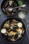 Pasta with mussels in shells. Spaghetti allo scoglio rustic style in cast iron pan