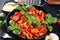 Pasta orecchiette. Plate of delicious orecchiette with tomato sauce garnished with parmesan cheese and basil on rustic background