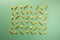 Pasta pattern on a colorful mint background. Repetition concept