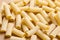 Pasta pattern. High angle view of a heap of uncooked whole wheat tortiglioni italian pasta. Food background