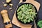 Pasta with pesto sauce is a traditional Italian dish. Rotini. Food background.