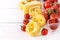 Pasta Products with Tomato Cheese Raw Pasta Fusili Fettuccine Ingredients Italian Food White Background Close Up Copy Space