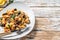 Pasta puttanesca with tuna fish, tomatoes, garlic and black olives. White background. Top view. Copy space