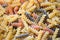 Pasta raw macaroni background, close up raw macaroni spiral pasta uncooked delicious whole grain fusilli pasta for cooking food -